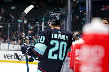 Tolvy leans against boards during warmups