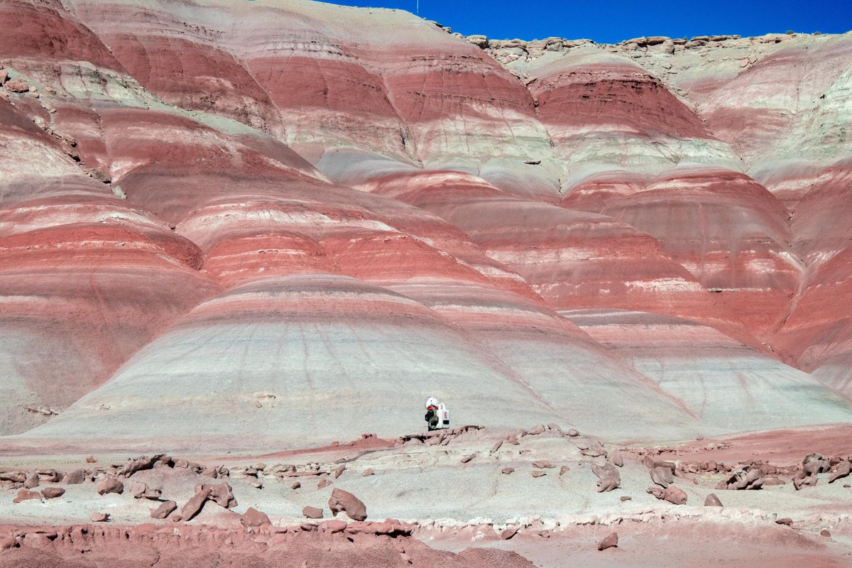 LOOK AT THAT VIEW!! 👩‍🚀👨‍🚀 A member of Crew 293 roaming the southern Utah desert some distance from our #MDRS campus during a scheduled EVA mission. #stem #marsanalog #analogastronauts @ISAE_officiel @MDRSSupaeroCrew #education