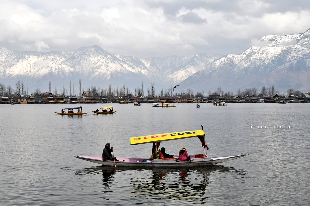 An intoxicating view of snow-clad mountains overlooking the Dal lake in Srinagar.