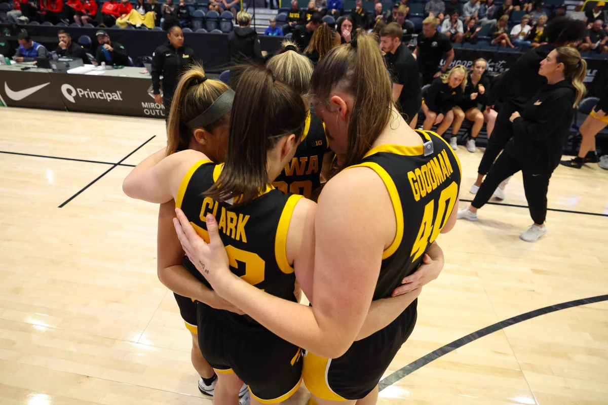 Iowa Women's Basketball seniors Caitlin Clark, Sharon Goodman, Gabbie Marshall, Kate Martin, and Molly Davis huddle during a game