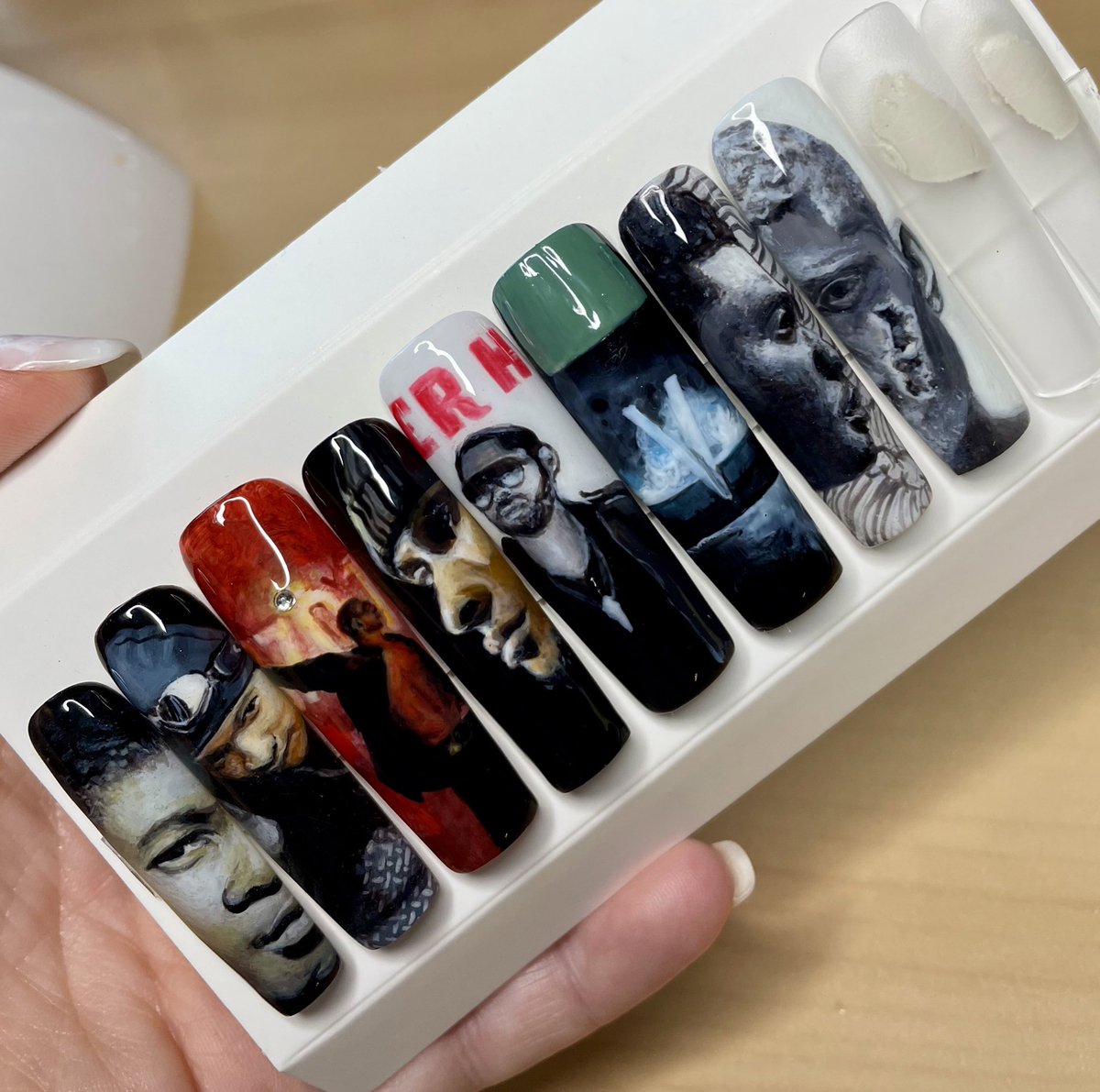 Creating press-on nails inspired by Usher's albums. Each nail represents a different album. Almost done and loving the results!