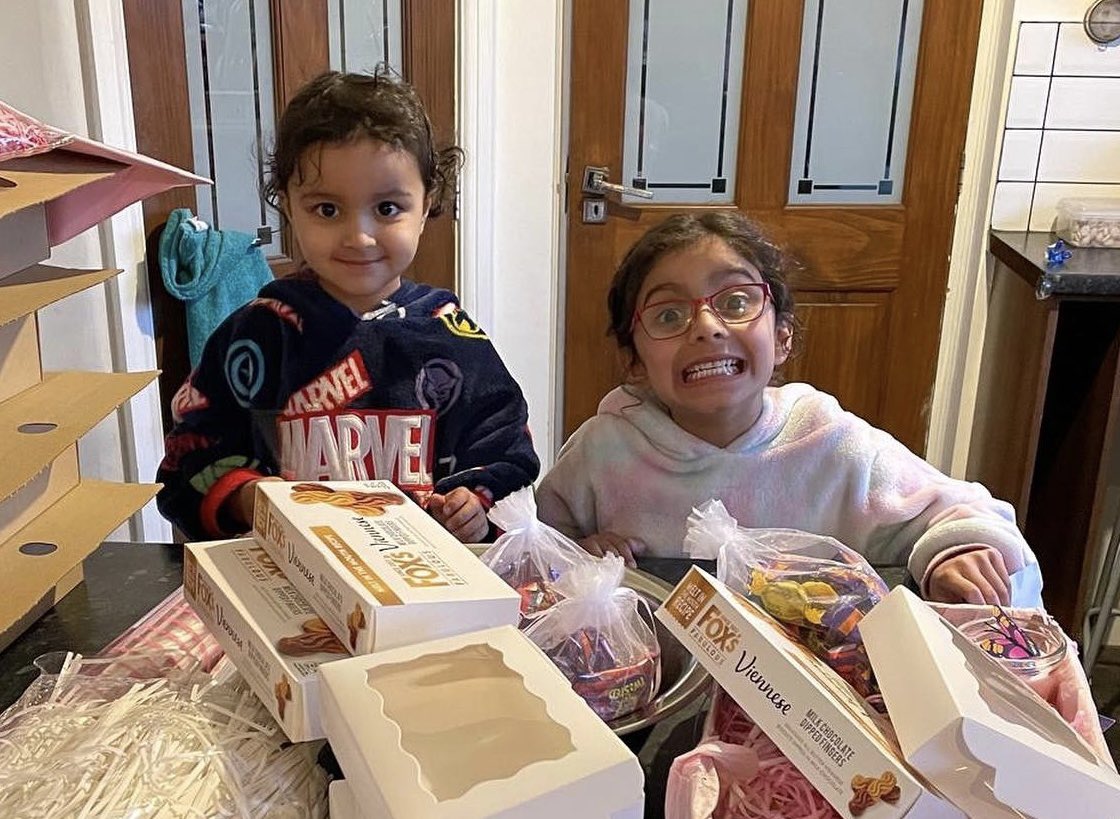 Just two girls packing boxes of sweets that will be distributed to celebrate and announce their girl cousin’s birth. I’m willing to bet this activity will be a core memory for them.
