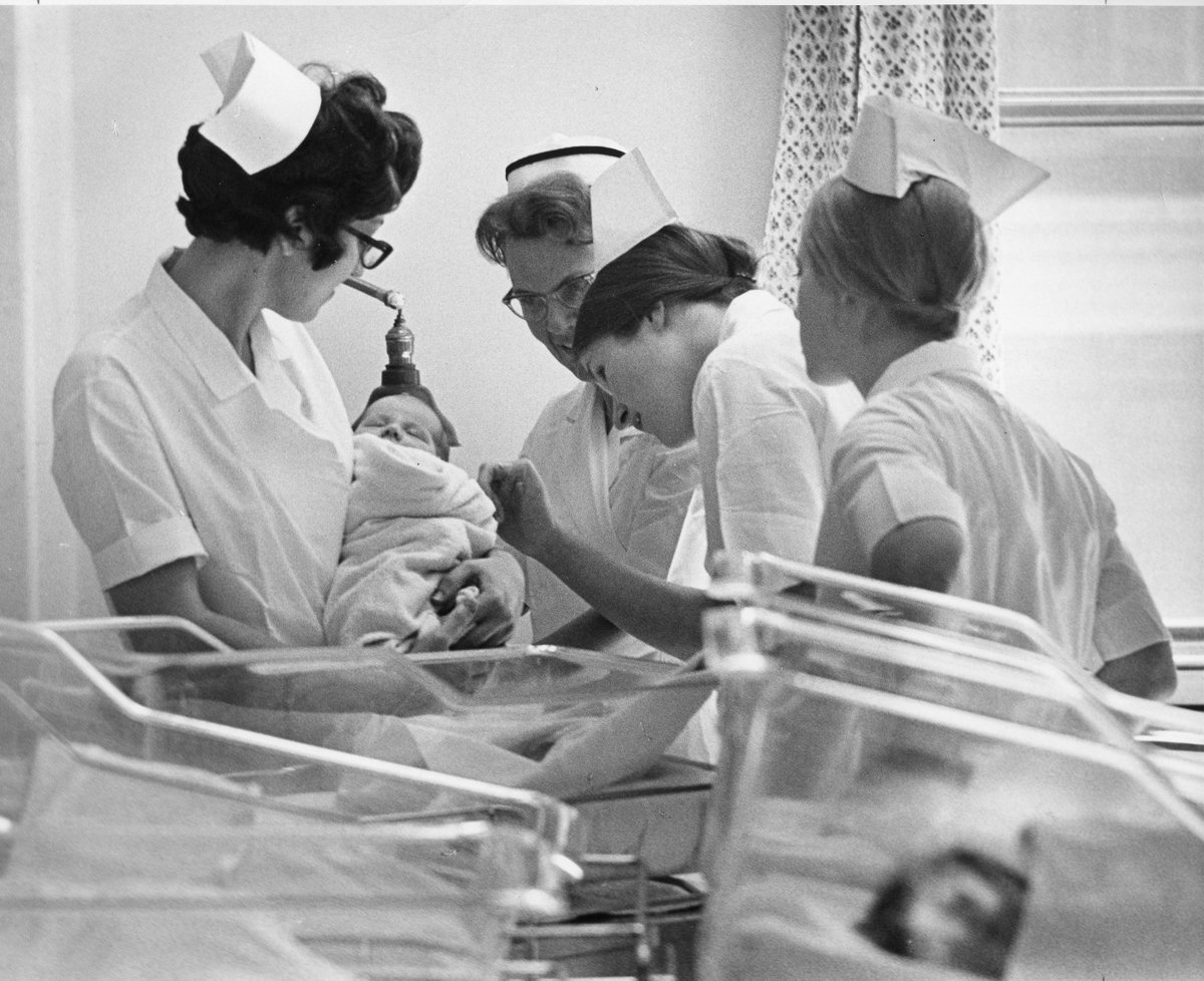 N is for nursing. Much of our collection relates to our nursing schools which operated until the 1970s. Here is a picture of nursing students with a baby. Credit: Roy Nicholls #ArchivesAtoZ