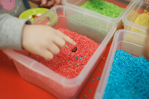 Engage your little one's senses with a homemade sensory bin! Fill a container with rice, beans, or pasta and add hidden toys or colorful objects for them to discover. #SensoryPlay #LearningThroughPlay #ModernParenting #forparentsbyparents
