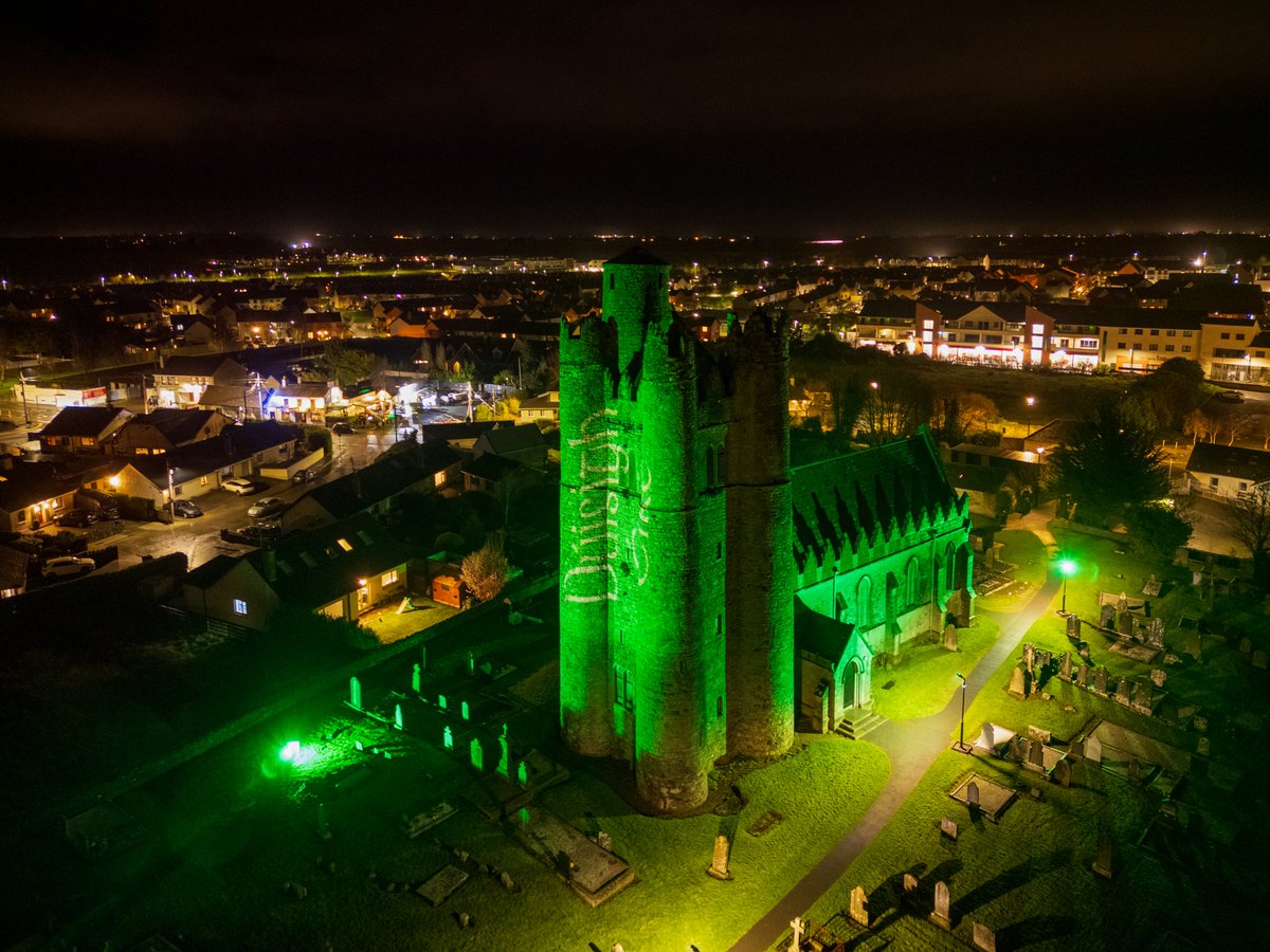 Lusk Round Tower lit up in green for St. Patrick's Day.