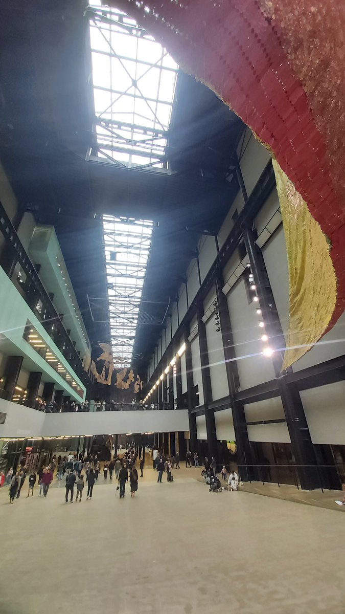 PhilipGlanville's tweet photo. Not been to @Tate Modern for a decade nor seen the new extension from inside, so yesterday was a jot. From the underground tanks to new gallery spaces it was wonderful to fall in love with the Tate again. Amazing seeing El Anatsui's #BehindtheRedMoon from below, across & above. https://t.co/9qQQ3EcjUt