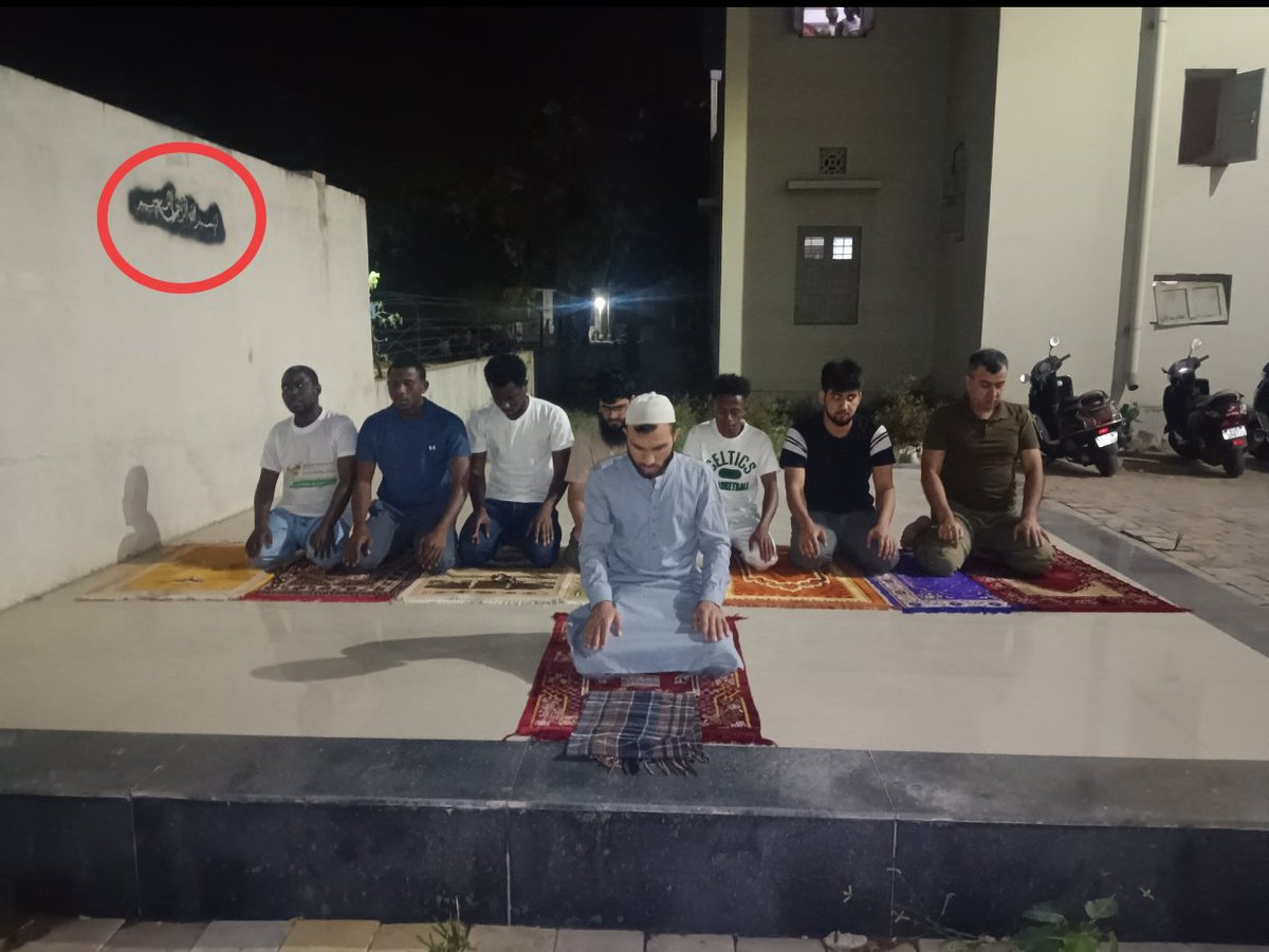 zoo_bear's tweet photo. One of the foreign students says, They've been offering Namaz in their block inside campus from the past few years after getting permission from the administration of Gujarat University. Who gives permission to Outsiders (Bajrang Dal members) to get inside the Hostel premises? Especially late in the night inside A-Block which is dedicated to International Students? Who are Bajrang Dal members to check on what students are doing inside their hostel block?

Many RW supporters on social media are claiming that the students were offering Namaz in open public space without permission. 
No. These students were offering Taraweeh Namaz at around 10 PM inside the Hostel compound of A-Block which has 75 foreign students staying in the hostel. They claim that they have been offering Namaz during Ramzan for the past 2-3 years with permission from the university. Foreign students studying in Gujarat are part of Indian Council for Cultural Relations (ICCR) which is under MEA. Hope they MEA takes cognizance.