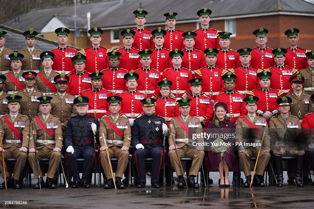 Lady Ghika, wife of the Regimental Lieutenant Colonel, Major General Sir Christopher Ghika, presents shamrock to Officers and Warrant Officers during a St Patrick's Day parade at Mons Barracks, Aldershot today The Princess of Wales is instead replaced by Lady Ghika. 📸Yui Mok