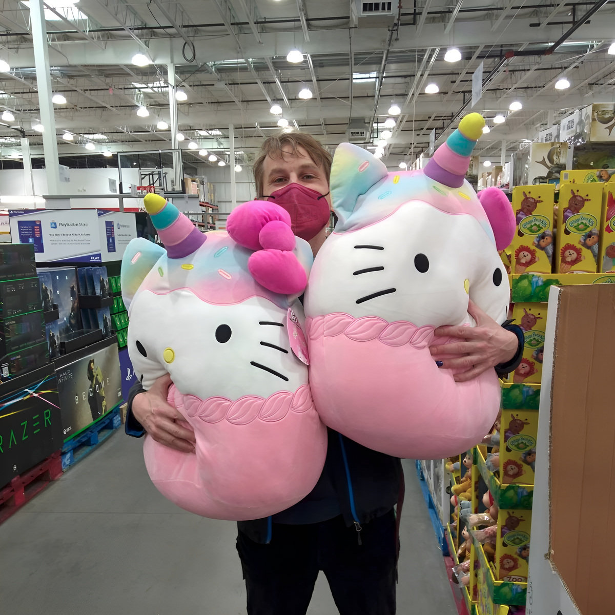 upd8 bc artist pic @Bandcamp tsx1.bandcamp.com the photo captures a lot about the current mindset, even at photo age >2, and where we are going person standing in a brightly lit warehouse holding two giant baby hello kitty unicorns in their arms (photo by eva hellsberg)