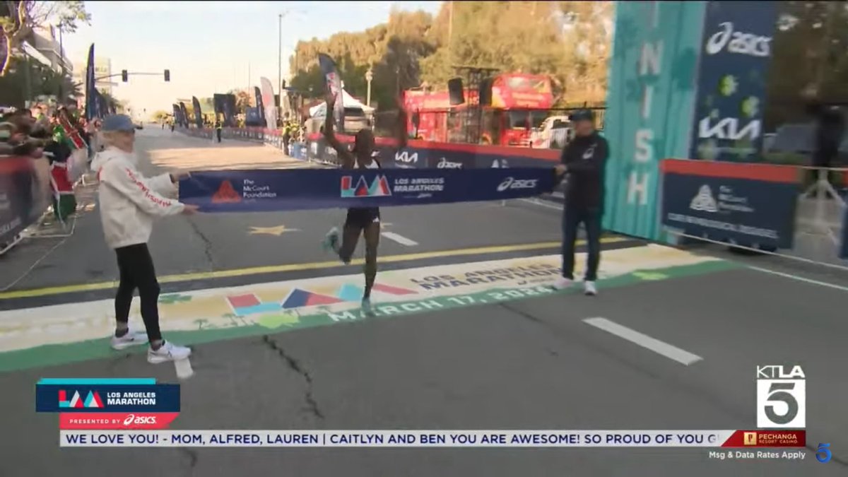 Stacy Ndiwa breaks the finish tape at the Los Angeles Marathon, held by Joan Benoit Samuelson, in 2:25:29. That's her second title in a row. Volha Mazuronak takes 2nd (2:25:49), Atsede Bayisa is 3rd (2:25:58), Kumeshi Sichala is 4th (2:27:07) & Makena Morley is 5th (2:30:25).