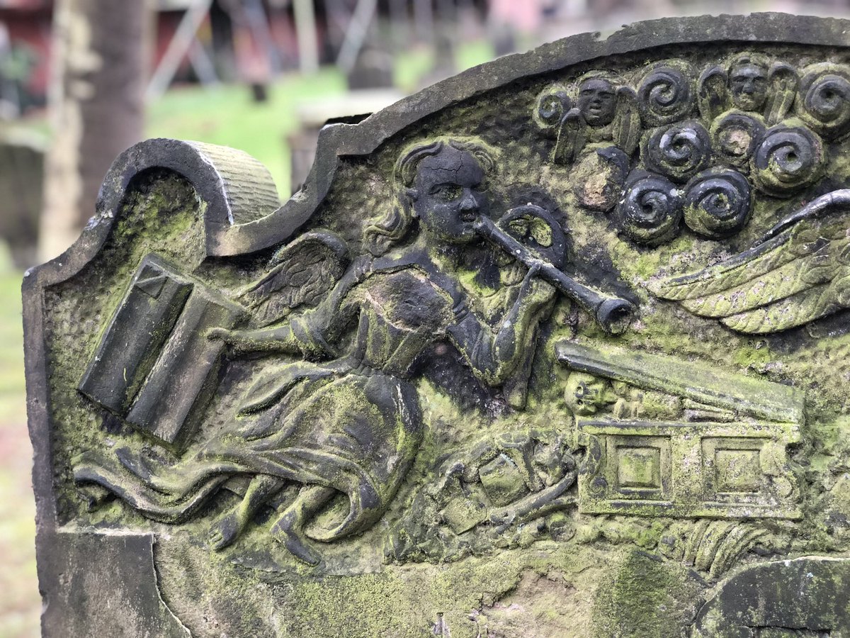 TheHatton's tweet photo. This gravestone shows us an Angel dressed like a Barmaid. Here she isn’t serving Pints, but summoning the dead to arise.  Judgment day has arrived &amp; she holds open “The Book”. A pensive looking skeleton rises from its tomb, whilst souls look on from the clouds. https://t.co/mp62ZSEPrP