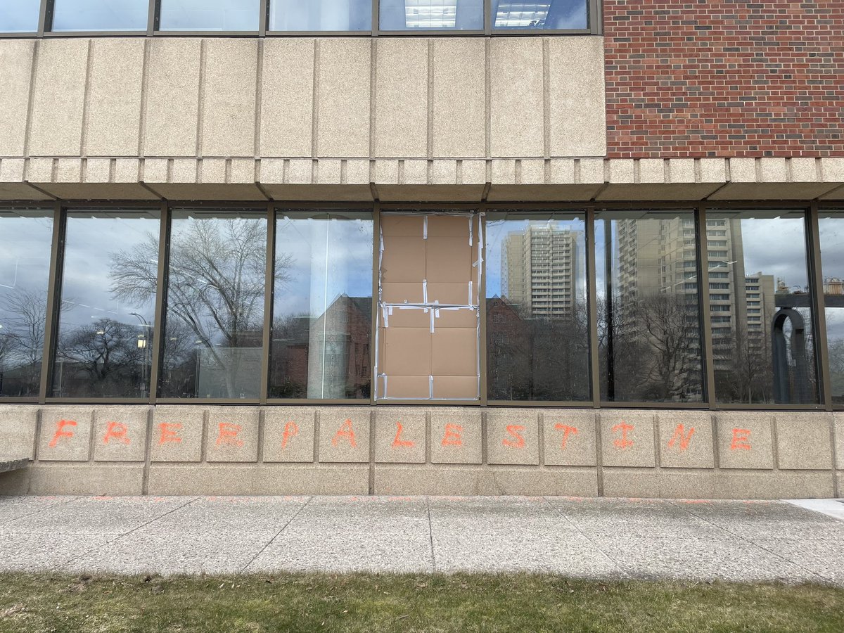 Here’s a photograph I took of Golda Meir Library on the UW-Milwaukee campus this morning - with a broken window and “Free Palestine” spray painted on it.