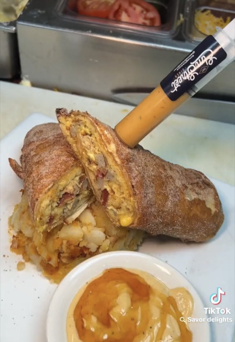 Dexerto's tweet photo. Would you eat this deep fried burrito made of pancakes, sausage, bacon, shredded cheese, and honey? https://t.co/iwAPKLoOIP