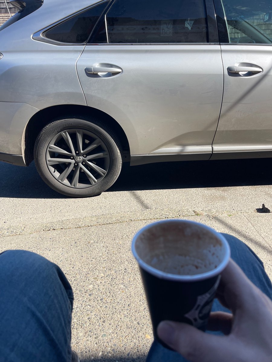 Enjoying coffee on the chairs out front of Caffe Vino Olio. What an enjoyable atmosphere 🙄 Sure is nice they put tables in this parking lot.