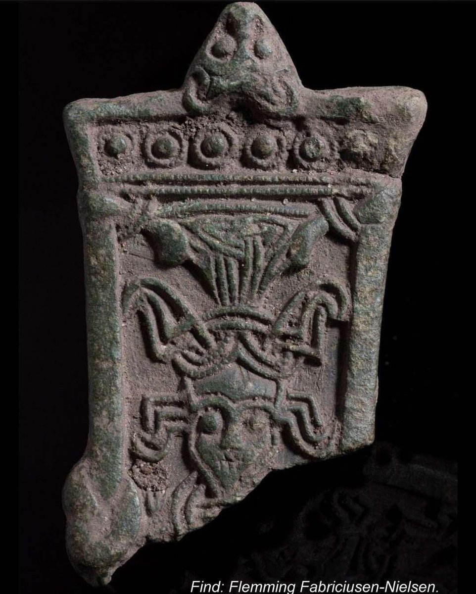 An image of Odin hanging on Yggdrasil, found in Zealand, Denmark, c.500-700AD.
One eye is damaged, and the lips look parched, as he hasn't eaten or drank in nine days. The 'horns' could be the heads of Huginn and Muninn. Note the Valknut/triquetra above his head.