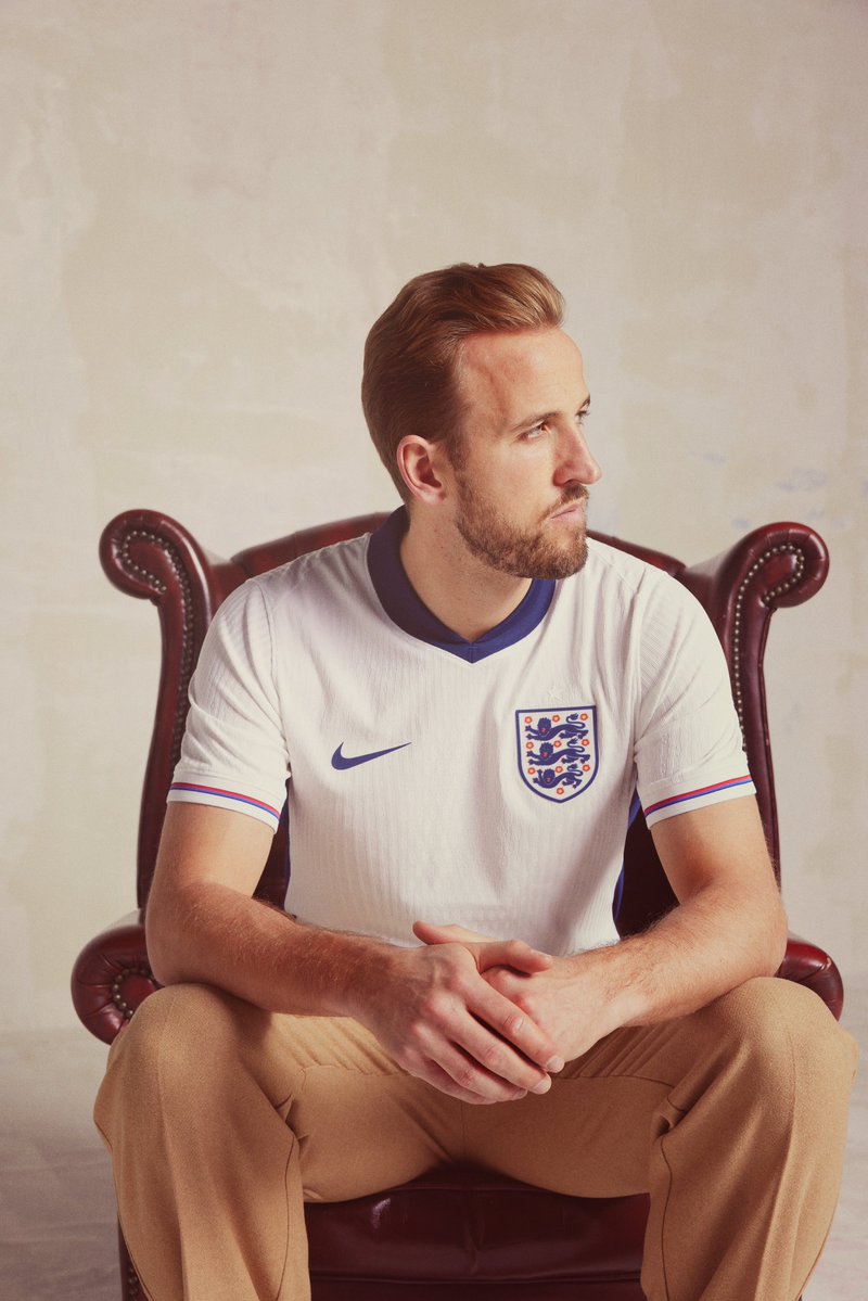 Harry Kane poses for a photo in the new England home shirt.