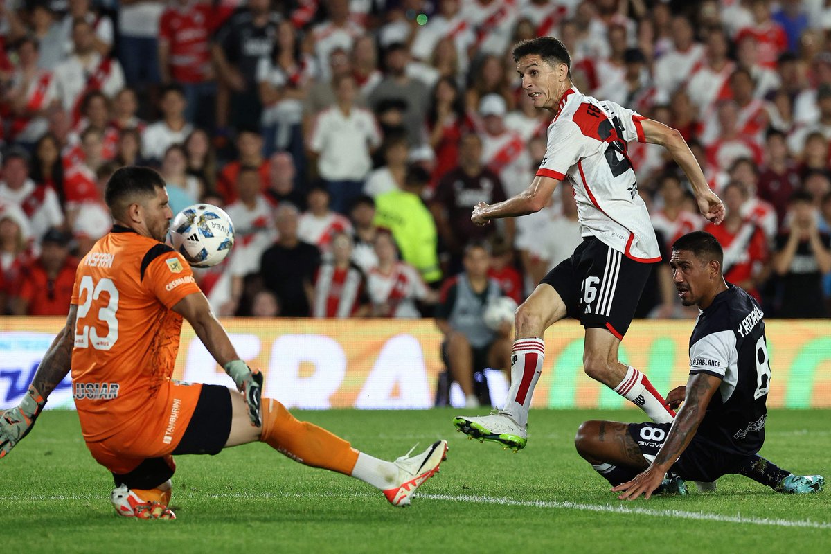 Gimnasia's goalkeeper Nelson Insfran(L)stops the ball kicked by River Plate's midfielder Ignacio Fernandez(C)during the Argentine Professional Football League Cup 2024match bet River Plate and Gimnasia at El Monumental Stadium in Buenos Aires on March17,2024.(Photo ALEJANDRO PAGN