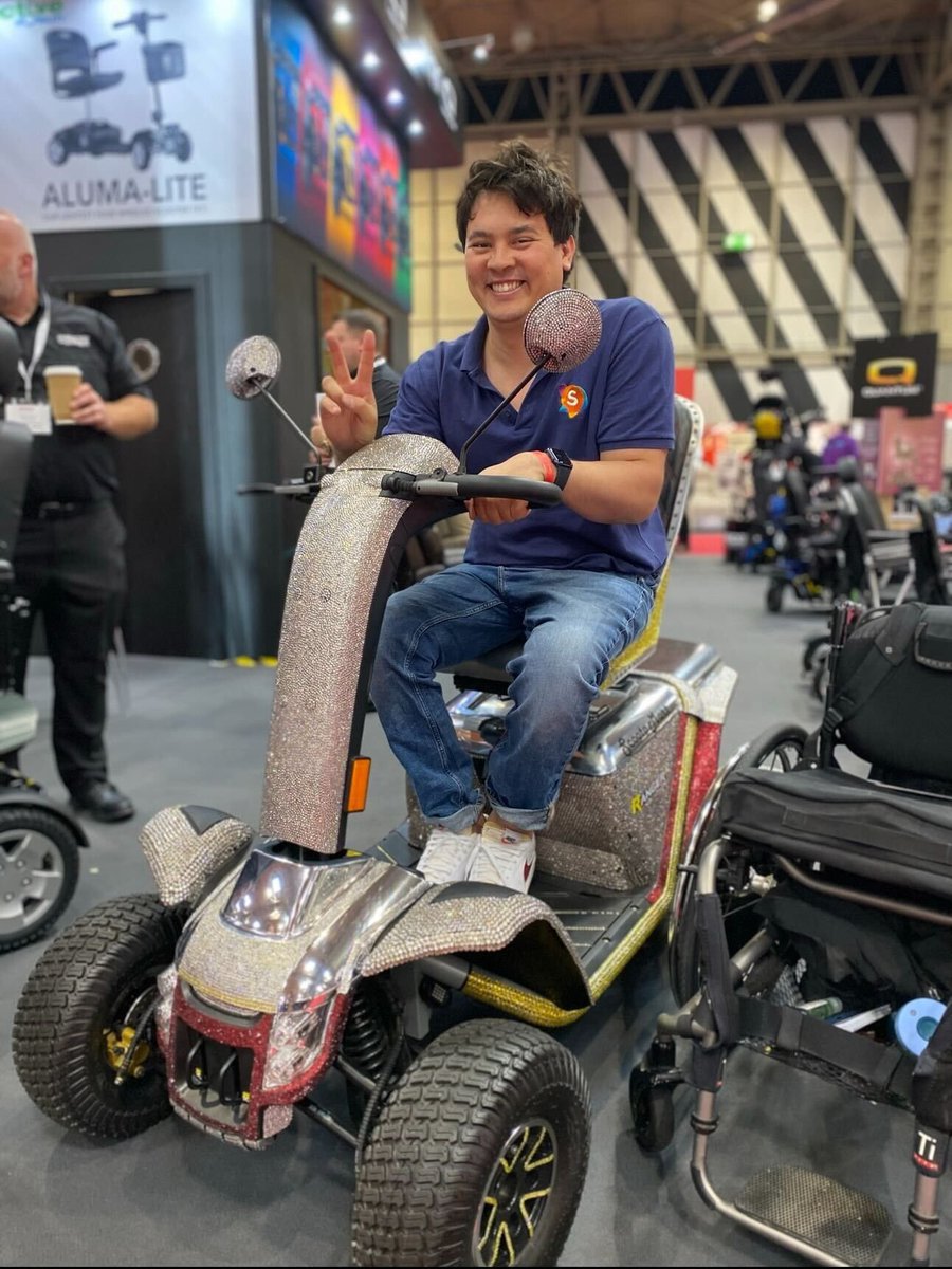 It’s @NaidexShow week! 🎉 Will we be seeing any of you there? 🤞🏼 Image description: A smiley brown haired man doing a peace sign, sitting on a sparkly mobility scooter.