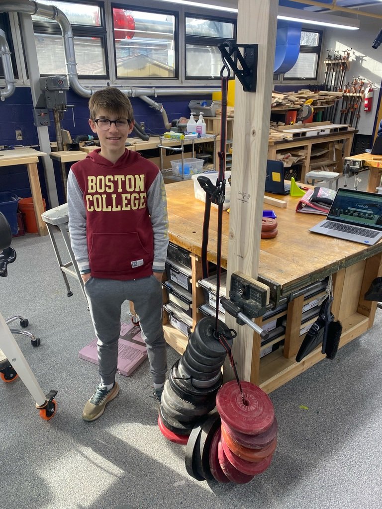 3D Design & Printing student Max Cirillo (gr 8) stands next to his 3D printed shelf bracket, which is supporting a whopping 201.3 pounds! #lionspride #mendhamborosd #mountainview