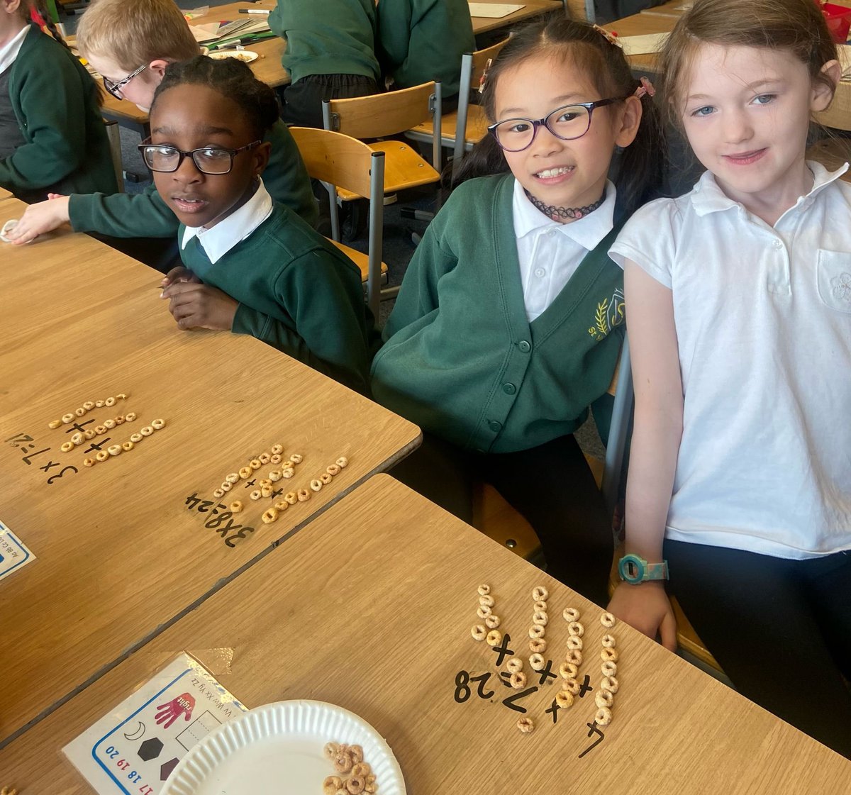 vincents_st's tweet photo. P2 were all engaged, working hard and having fun in numeracy today! They chose their favourite strategy that they had learned (arrays, repeated addition or equal grouping) and used it to help them with multiplication, showing their working using cheerios! @glasgowcounts https://t.co/0HWmwESPns