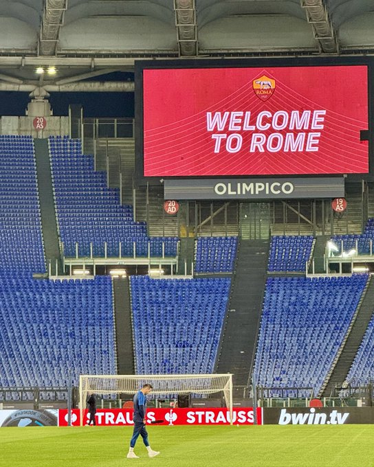 Wide-angled view of Stadio Olimpico with Roberto walking across the pitch with the big screen reading ‘welcome to Rome’ in the background. See you all soon!