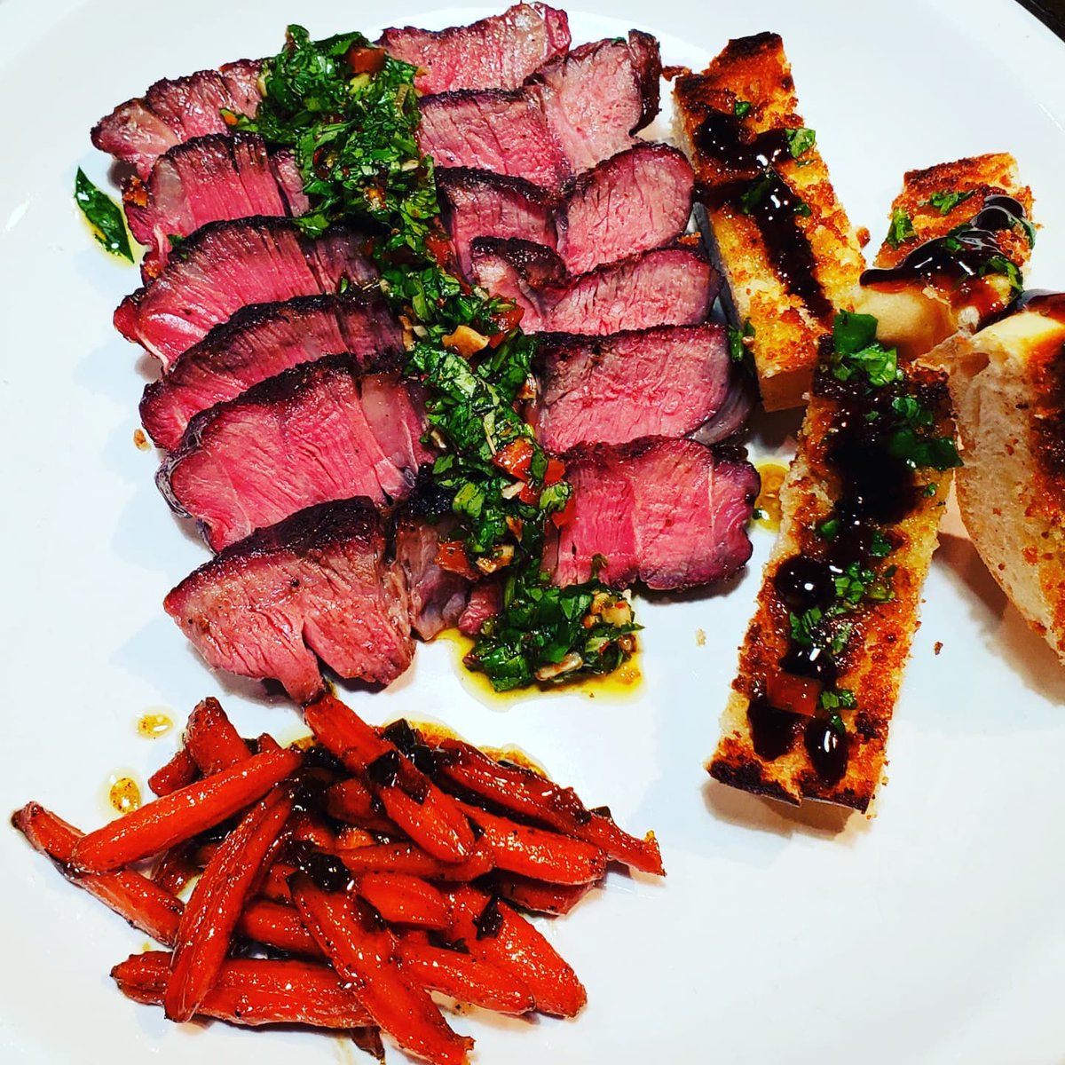 Smoked, reverse seared ribeye! Smoked for 45 minutes at 180° then seared over hot charcoal. Absolutely phenomenal! Homemade chimichurri sauce, homemade garlic bread with a balsamic reduction and a side of caramelized honey glazed carrots. 

#ilovecooking
#itsmypassion