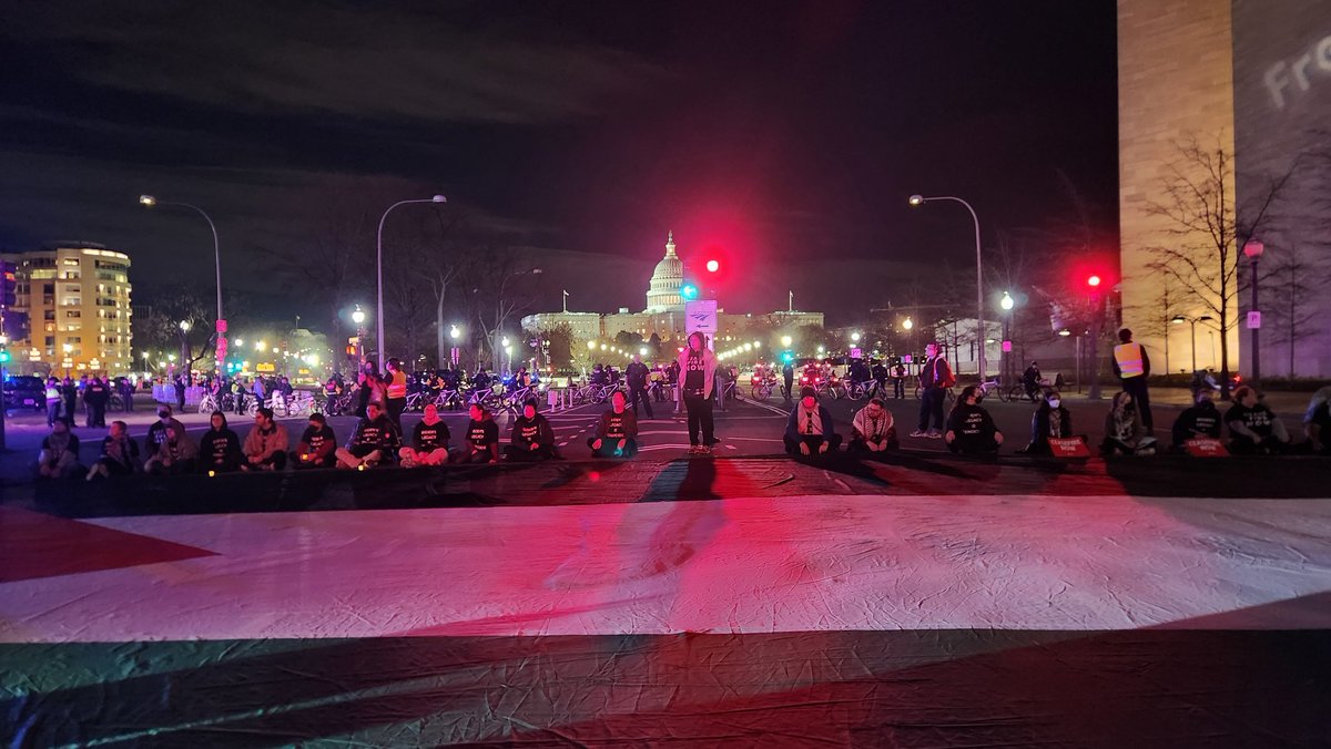 adrien4ej's tweet photo. TONIGHT: Why was the #StateoftheUnion delayed? Because hundreds of us blockaded Biden's motorcade route for hours, demanding a permanent #CeasefireNow, an end to the genocide in Gaza, and the US to #StopArmingIsrael. Biden's legacy is genocide. #DivestFromDeath #InvestinLife https://t.co/KcSLbFtqeU