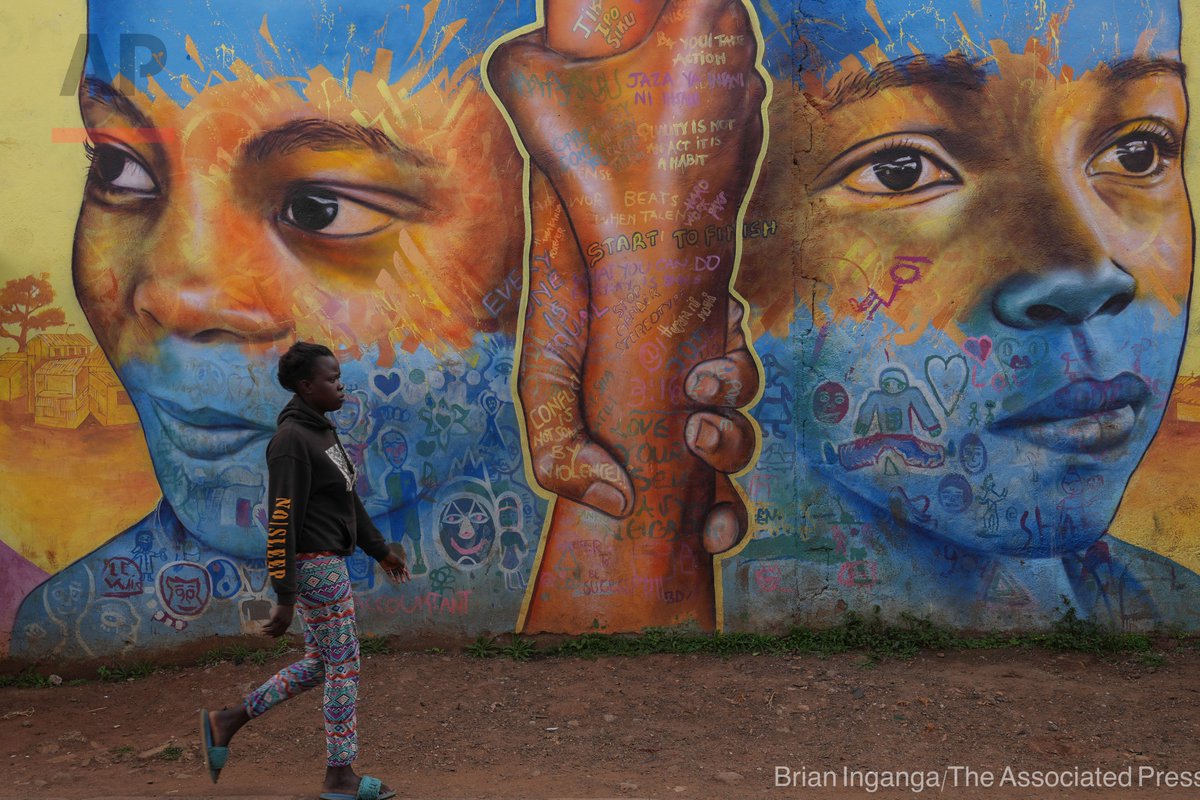 A woman walks past an informational mural against gender based violence, on a street in Nairobi, Kenya, March 6, 2024. Globally, 1 in 3 women experiences either intimate partner violence or non-partner sexual violence during their lifetime, according to the WHO.