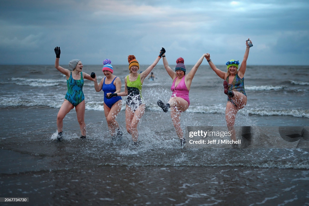 Swimmers take part in a sunrise dip in the NorthSea at Portobello Beach, to mark #InternationalWomensDay in #Edinburgh, #Scotland. I March 08, 2024 I 📷:  Jeff J Mitchell #GettyNews