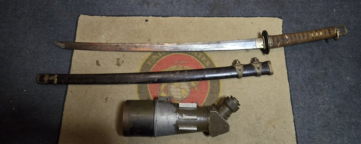 Last one of my collection. Sword was bought back from Guadalcanal by a Marine friend of my Dad's, the brass artilery sight from Iwo Jima. Dad was a Marine in the early 1930's, but was too old for WWII