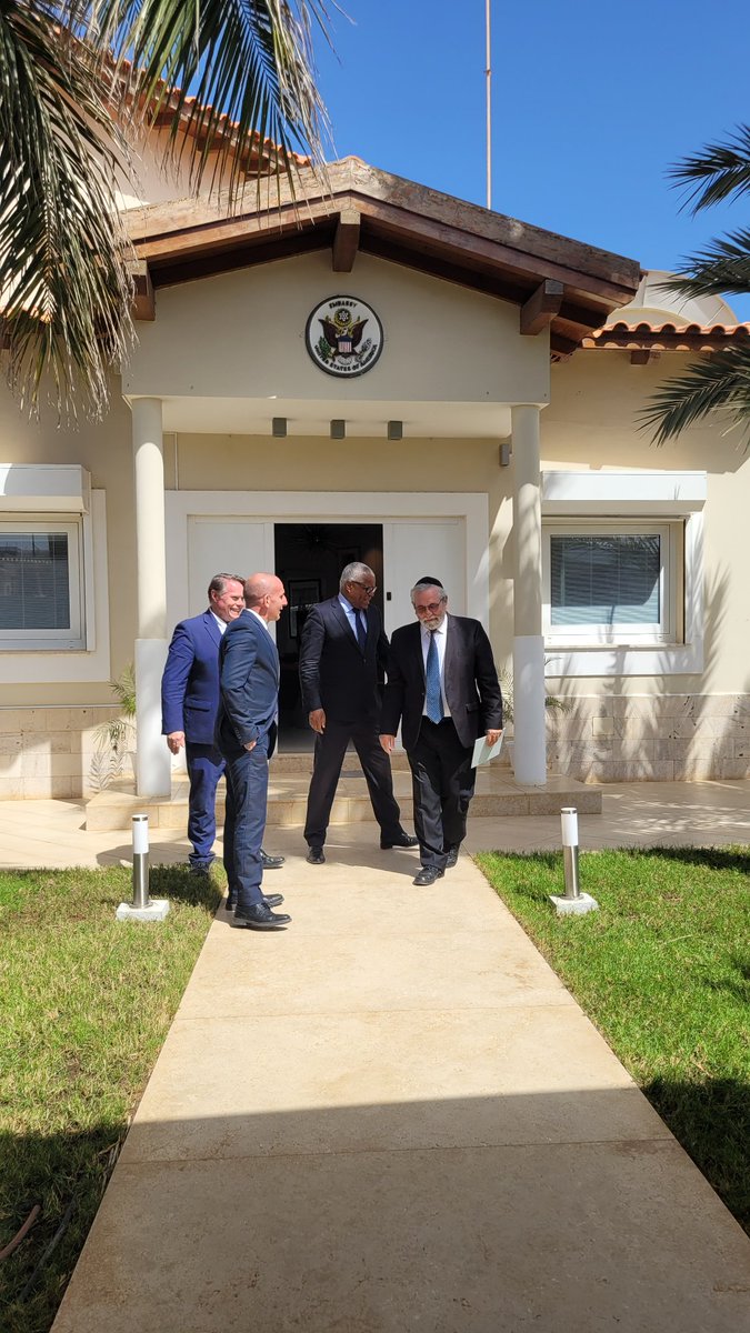 CVJHP's tweet photo. Left: Mindelo, São Vicente José  Cabral and @Carol_Castiel exchange books. Right: leaving US Amb. Jeff Daigle's residence in Praia with dignitaries attending @CVJHP #Moroccan Jewish events. Amb. Daigle @StateDept is a US national treasure! Thank you for your leadership. https://t.co/irgf1Nl73g