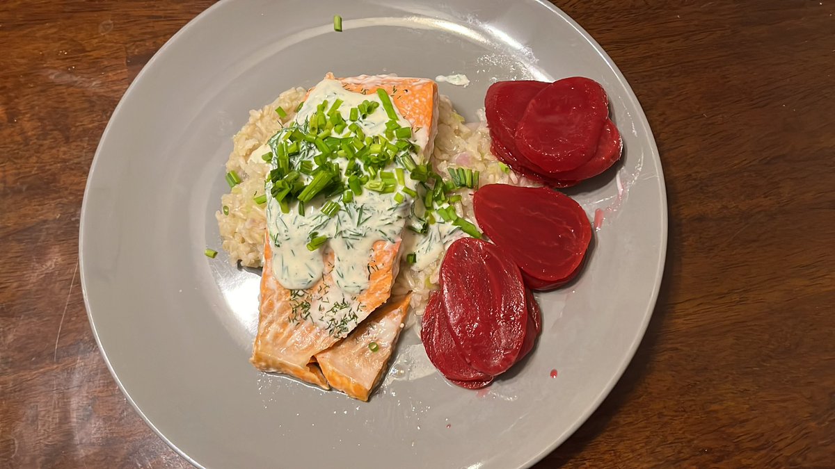 Baked salmon with dill cream sauce over brown rice pilaf with some sliced beets.