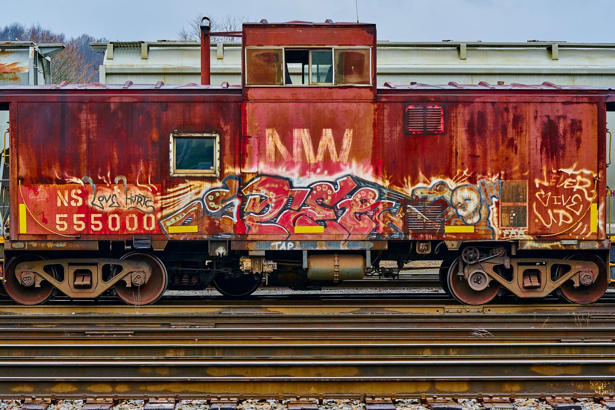It was a rainy day at the Radford, Virginia rail yard. The vibrant red paint and #graffiti caught my attention. #photography #PhotographyIsArt #Railway #kaboose #train #fineartphotography #graffiti