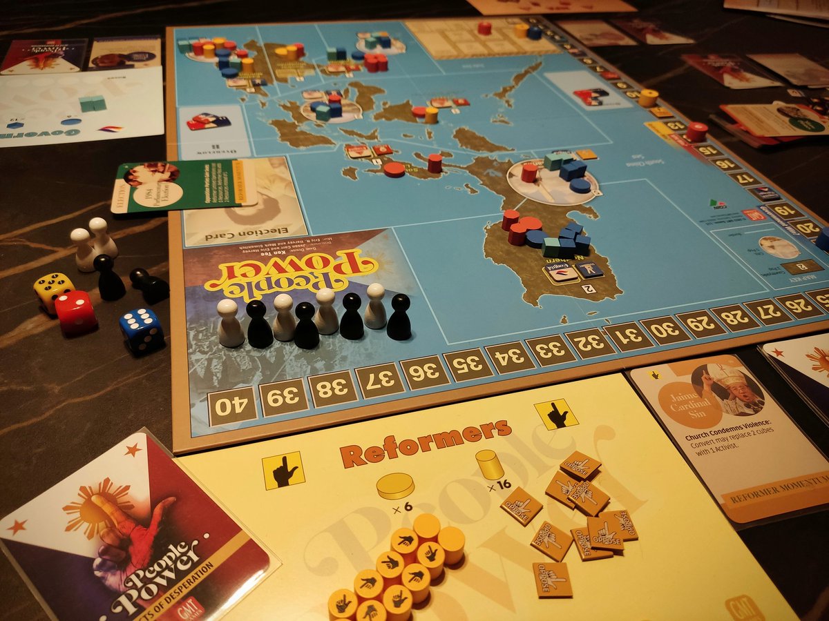 PCaproens's tweet photo. Giving the newest COIN game 'People Power' by @gmtgames a spin tonight with @Hans_Goossens85 and @Scr3p. Really loving the 3 player design. Fun pressure to try and  maximize every choice with the extra benefits from the personality cards during the campaigns. https://t.co/BTvmgGpkkW