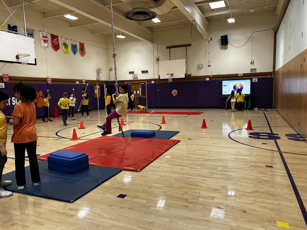 PEwithCoachY's tweet photo. Swinging into the weekend during gymnastics stations with our @ChurchStreet_WP Champions! 
Students practiced rope swing, roller racers, stick exchange and their rolling and animal walk skills. Love incorporating our Ben Q board into the stations #physed #technology #elementarype https://t.co/0FBclqlGek
