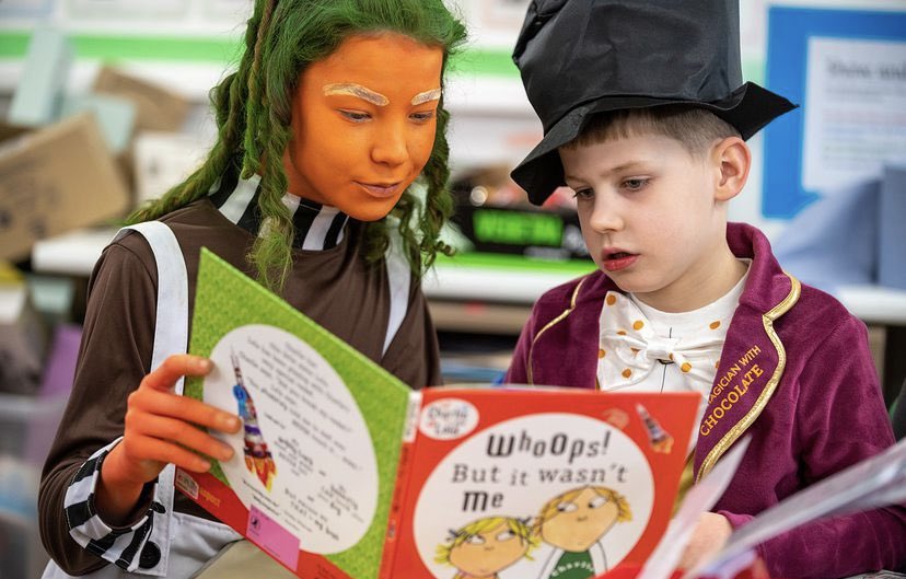 CCSDeputyHead's tweet photo. #WorldBookDay2024 is always one of my favourite days of the year. When else do you get to dress up as a pink flamingo! But what I love even more is seeing our older pupils @CastleCourtYr7 reading to our younger ones @CastleCourtPre. The @CastleCourtPrep family at its best. https://t.co/FhRKClA3wz