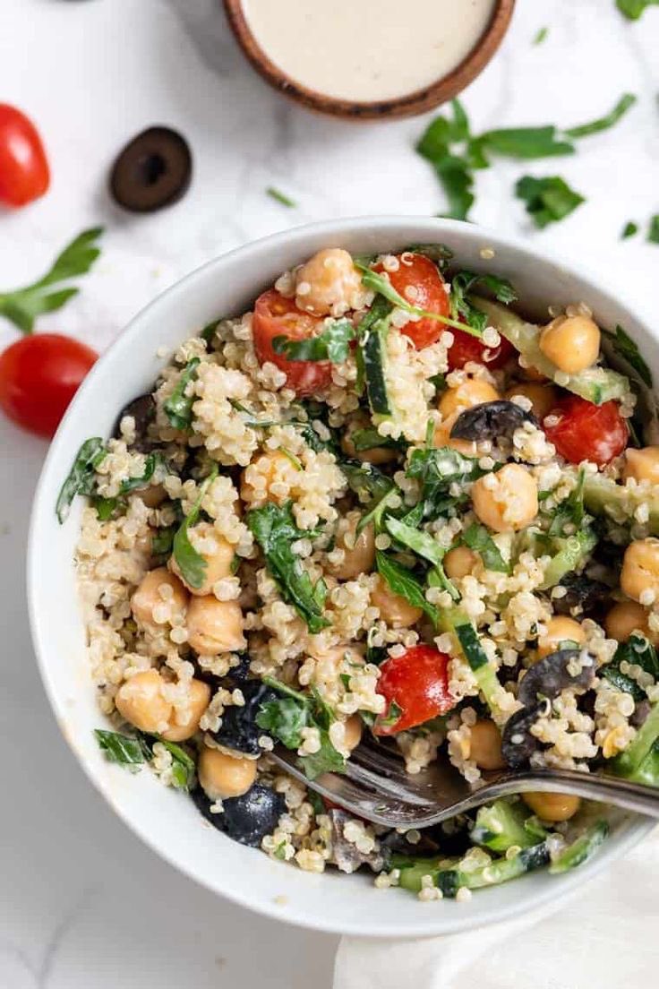 Healthy quinoa breakfast with cooked quinoa, chickpeas, green mint leaves , tomatoes, red and black olives . #vegan #healthy #green #nodrugs #nowar #food #lifestyle