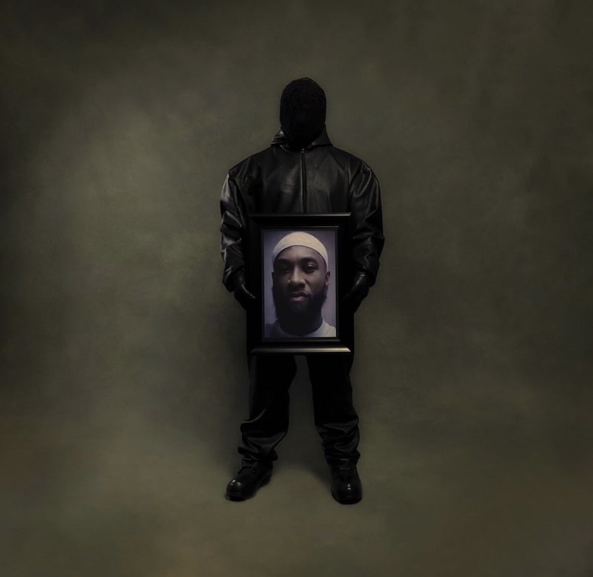 DondaTimes's tweet photo. VULTURES 2 album cover, representing Ye holding a portrait of Ty’s brother Jabreal Muhammad, who has been given a life sentence at the age of 19 for a crime he says he didn’t committed https://t.co/04Knt7Mlzc