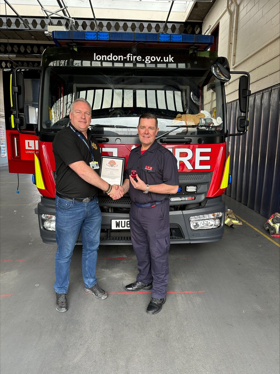 Firefighter Dean Lawson at Homerton Fire station receives his 25 year FBU badge from Regional Organiser Gareth Cook