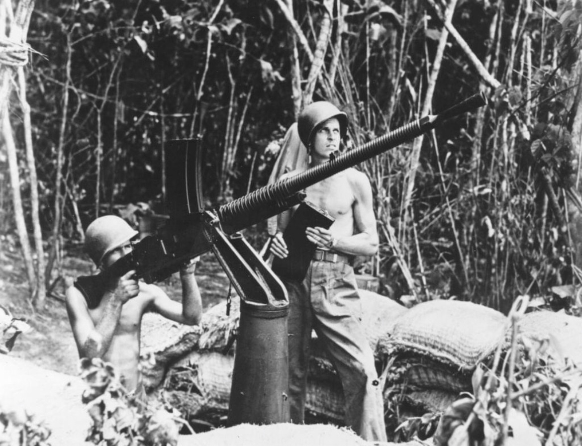 In 1942, Marines fire a captured enemy machine gun at Japanese planes during the fighting on Guadalcanal. 🪖