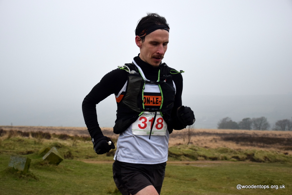 Chris Holdsworth Clayton Le Moors passing the 'Literary Landscape' of the Bronte Stone Books on his way to victory at the Haworth Hobble 32 mile fell race in a super fast 3.55.25 @ClaytonleMoors @AthleticsWeekly @kcacuk @inov_8 @Fellrunninbrief @FellrunningUK