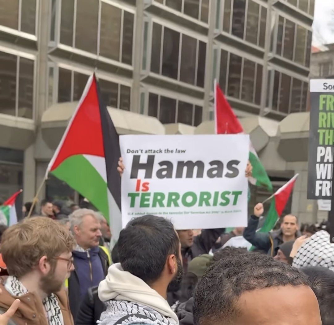 Moments before the man holding this sign was assaulted and then arrested. 

Yes. The assaultee was arrested. Because that's the state of the world.