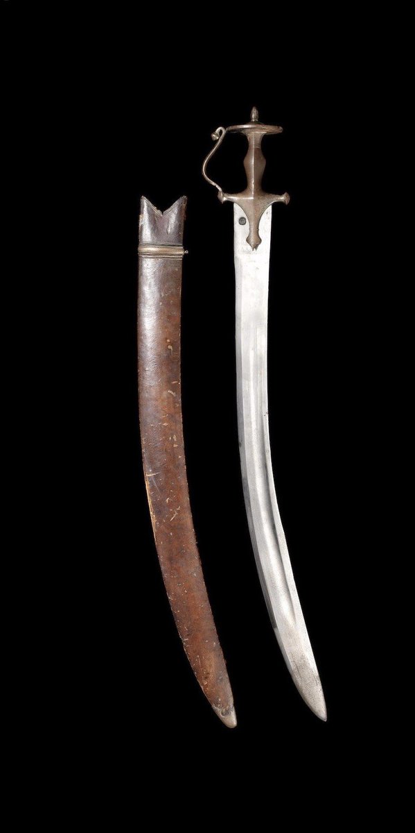 A large Mughal steel-hilted Executioner’s Sword (tegha). Northern India, circa late 18thC, with a blade that becomes slightly wider before tapering to a point.

Overall length =  47' or 121cm