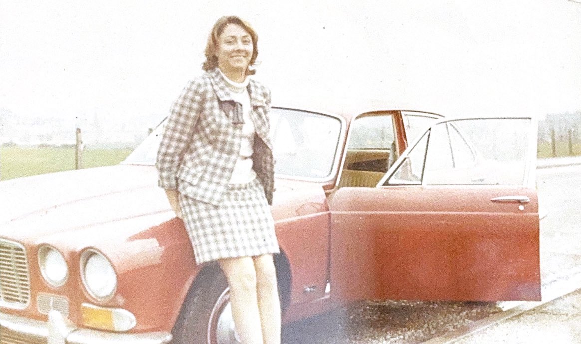 This was my mother … 20 years younger than I am now … about the time she was “greeting a man from the motortrade” .. aka my dad! 
Wearing a suit that she made, driving the first Daimler to be brought into Lancashire .. after driving a bus to St Ives