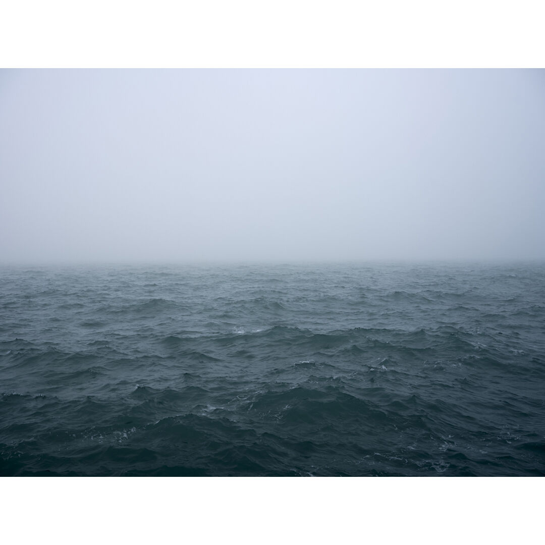 The landscape is constricted by the fog that surrounds me while the lake stirs restlessly underneath the dense morning air. This limited edition photograph is from the Lake Series, February 6th, 2024.
