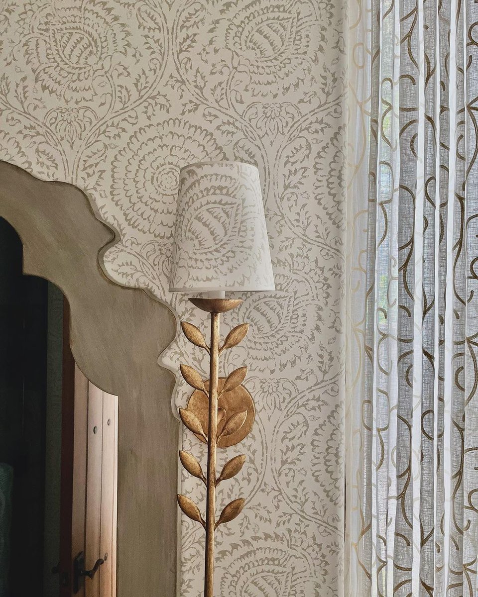 Expert move: Achieve harmony and cohesion in your space by matching the shade of your sconces with the room's wallcovering, creating a seamless and polished look. Featuring Kamala G.P. & J. Baker Designer: attitude Design Interiors