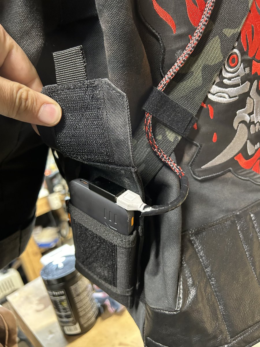 TheRealEvanCray's tweet photo. Some more updates! Cybernetic forearms are painted with their base red. The gloves are repainted to be red. And I think the jacket is done…for now. BUT! It runs under its own power now with a small power bank that I keep on the strap on the jacket. #cyberpunk https://t.co/HETFvNUsIF