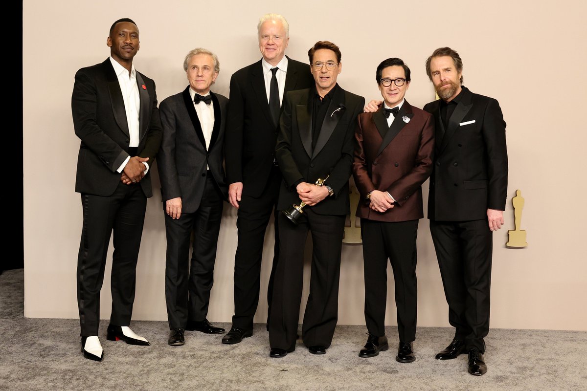 Robert Downey Jr. celebrates his #Oscars win alongside presenters Mahershala Ali, Christoph Waltz, Tim Robbins, Ke Huy Quan, and Sam Rockwell backstage in the press room.