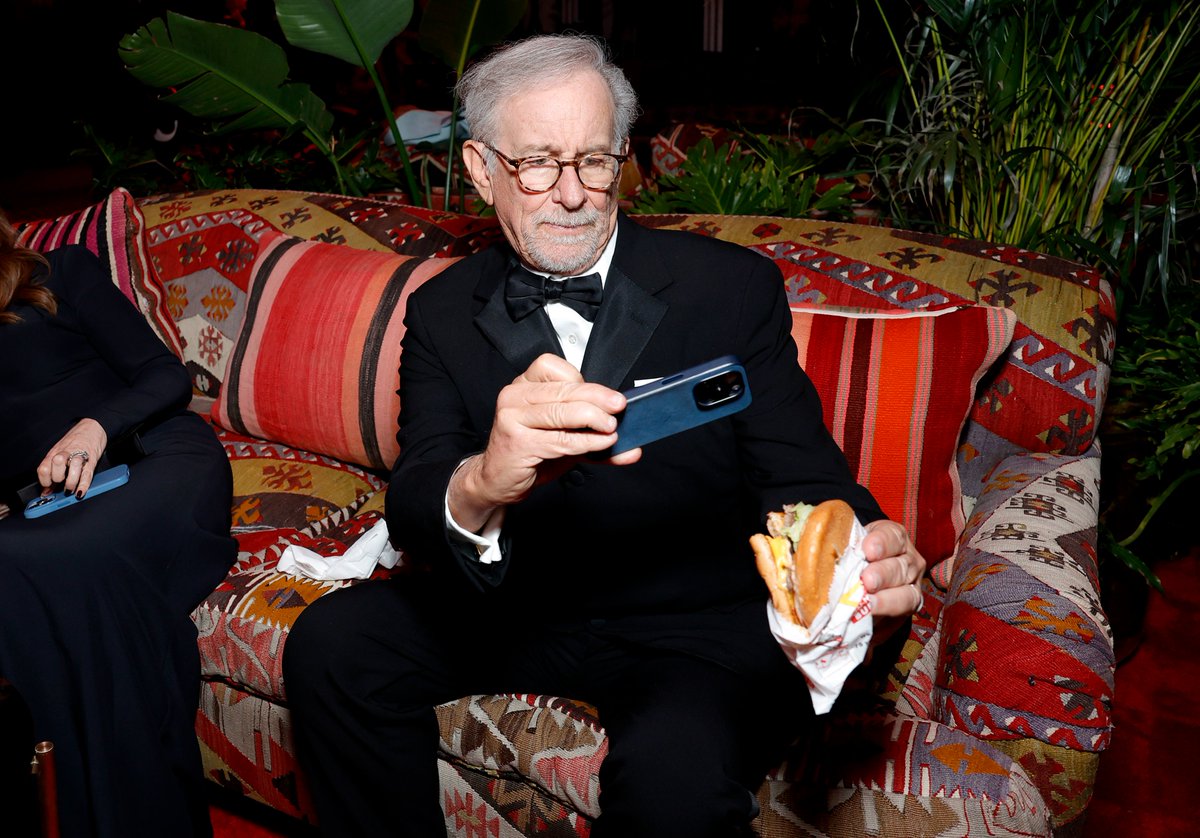 Steven Spielberg takes a picture of his burger inside the #VanityFair party. #Oscars