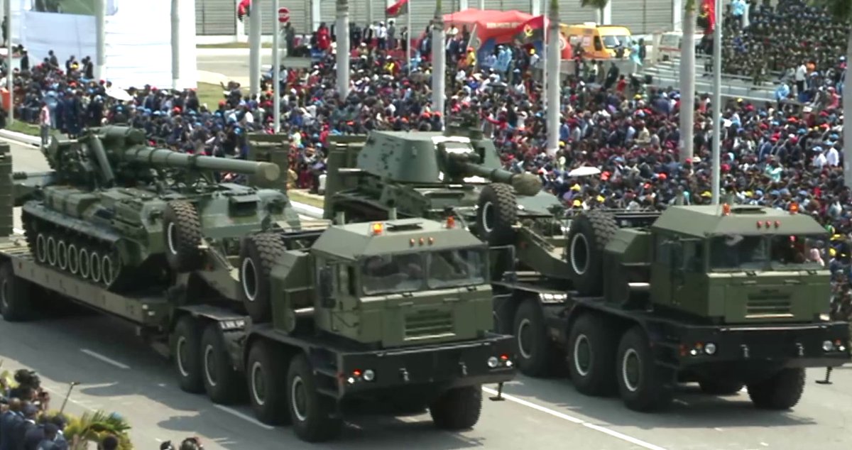 Angolan army 2S3 Akatsiya 152.4 mm self-propelled howitzer and 2S7 Pion self-propelled 203 mm cannon, loaded on two Belarus-made mzkt -742960 tank transporters ,during a military parade